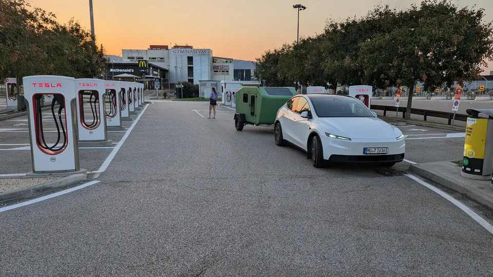Tesla Model Y with the Glide at the Affi Supercharger in the first light of morning