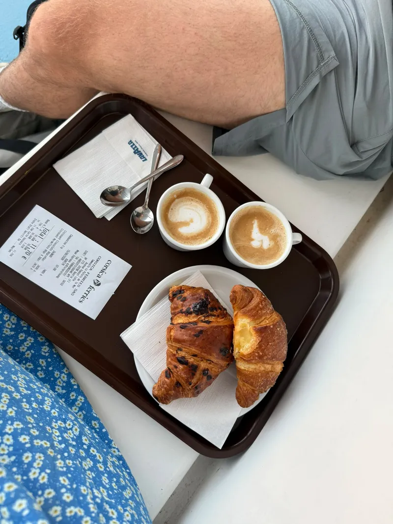 Two cappuccinos and croissants on a tray on the ferry