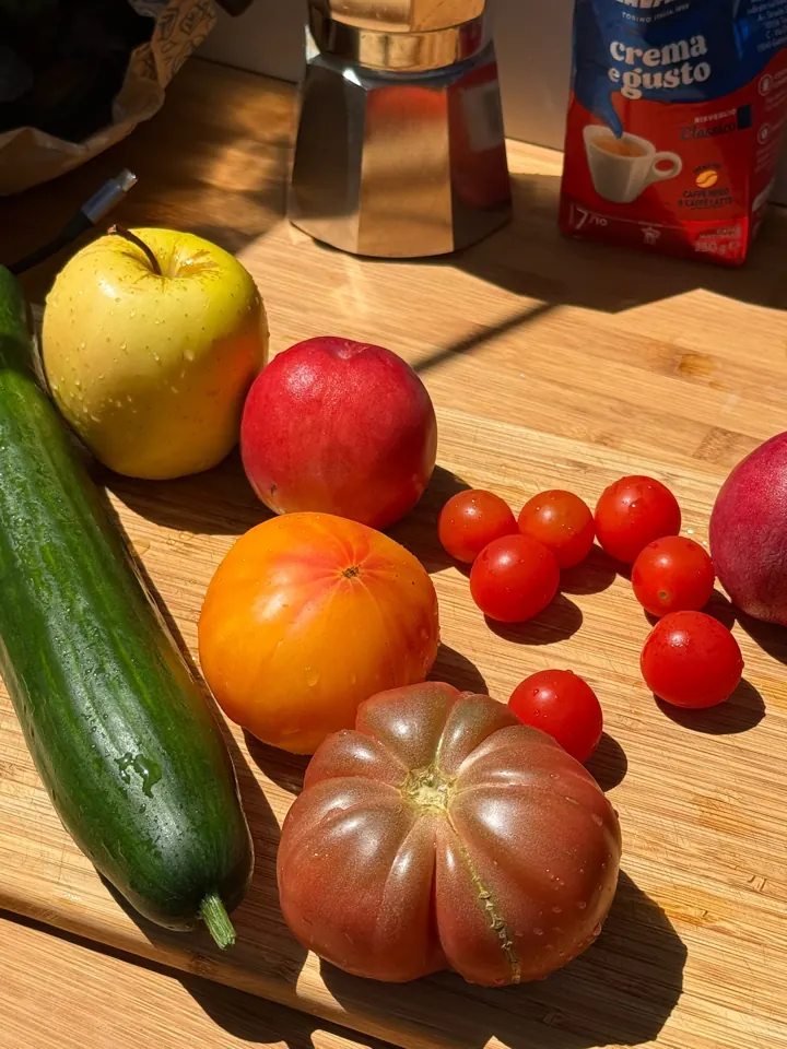 Fresh fruit and vegetables, espresso pot and coffee on the bamboo worktop