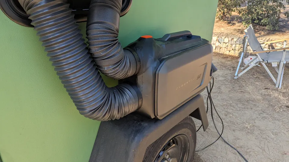 Portable air conditioner connected to the side window with two hoses