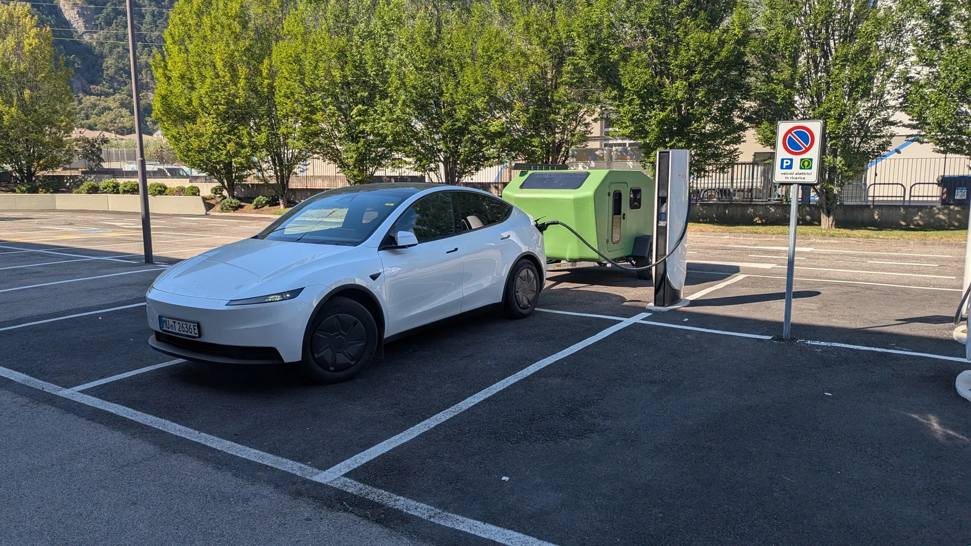 Tesla Model Y with the Glide hitched at a Supercharger in Italy