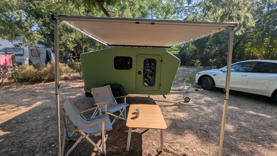 Extended awning over table and chairs in front of the Glide