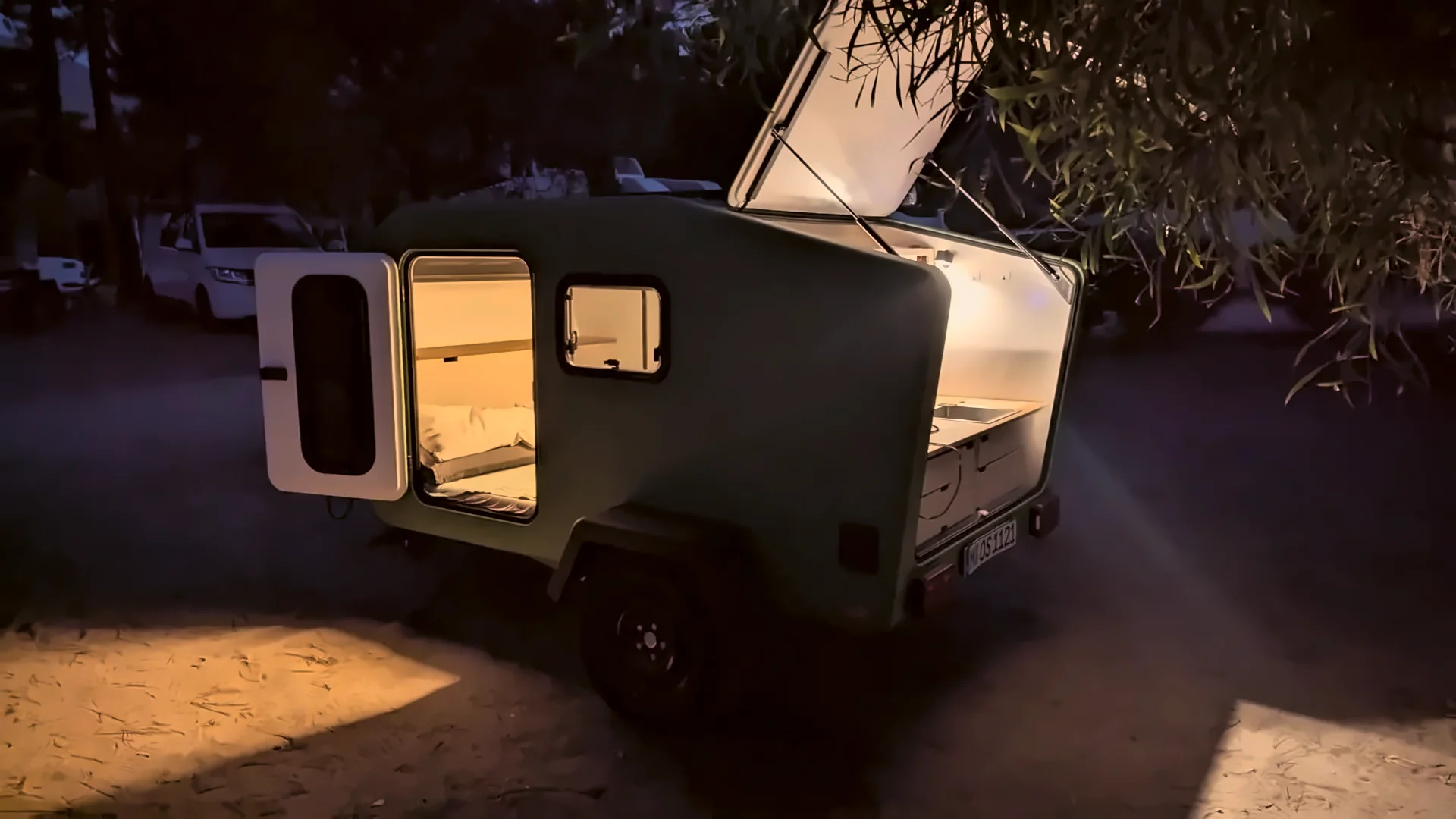 Glide at night with open door and tailgate, warmly lit inside