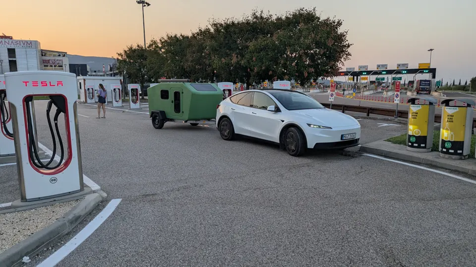 Tesla Model Y with Glide at a Supercharger on an Italian motorway in the evening light
